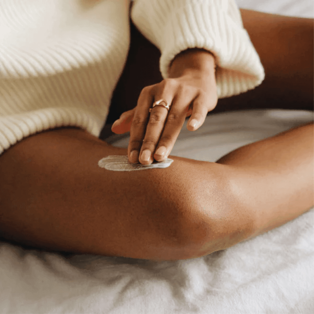 Women applying Soothing Balm onto leg eczema