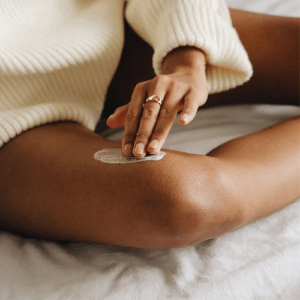 Women applying Soothing Balm onto leg eczema